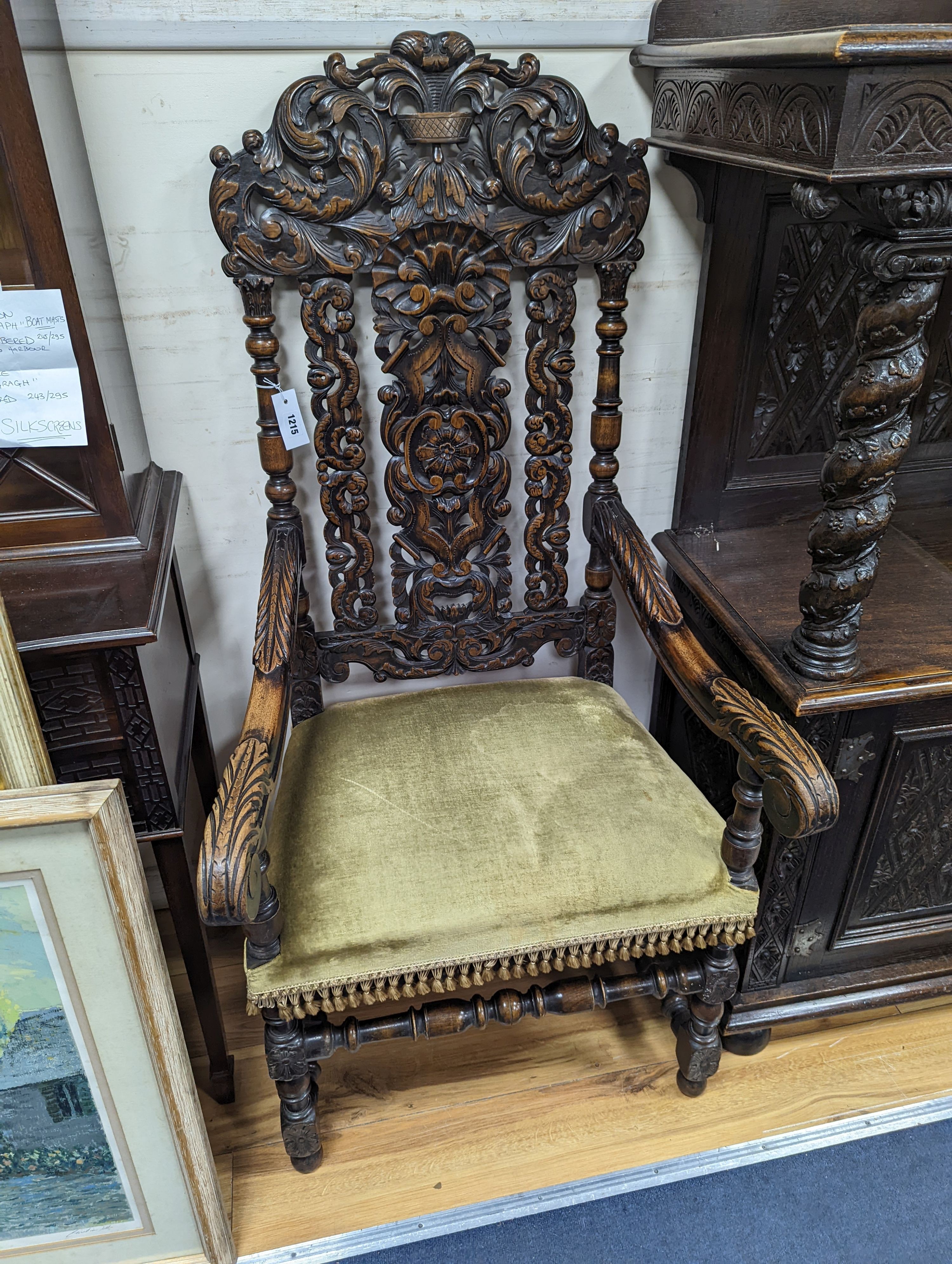 A pair Charles II style carved oak elbow chairs with upholstered seats on turned underframes, width 63cm, depth 54cm, height 133cm